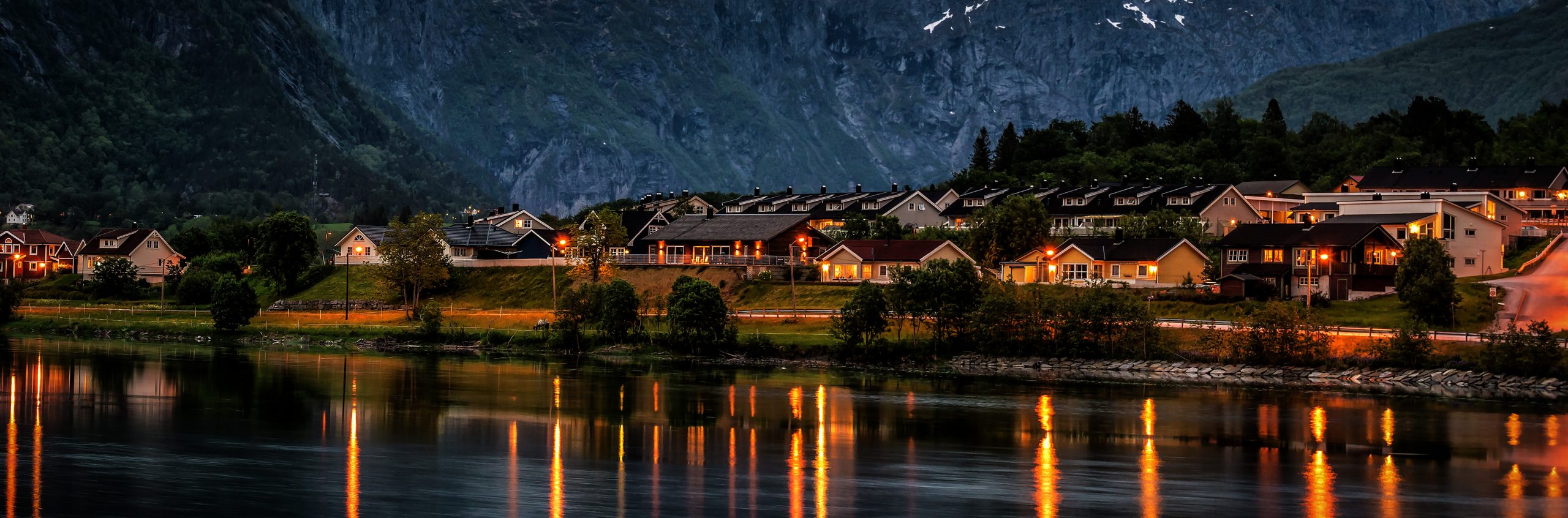 Village under mountains in Norway after sunset